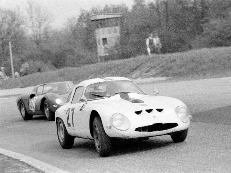 Chassis number 750061 (#27) leads SEFAC Ferrari 330 P2 (#60) through a turn at the 1965 1000 KM of Monza.