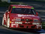 The Alfa Romeo 155 TI touring car tackles the kerbs at the Hockenheimring during the 1994 DTM season.