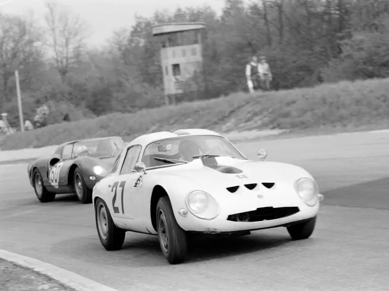 Chassis number 750061 (#27) leads SEFAC Ferrari 330 P2 (#60) through a turn at the 1965 1000 KM of Monza.