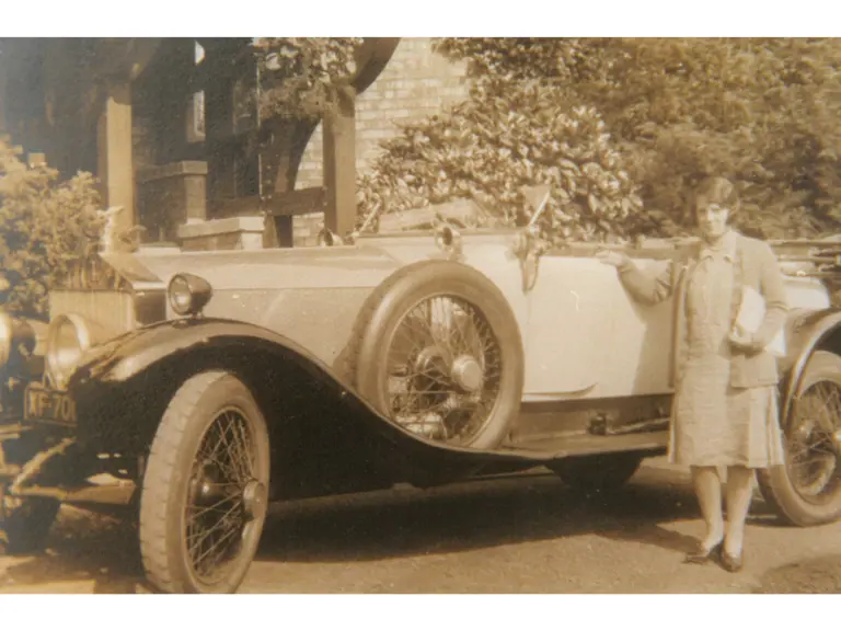 Marion Stuttard, wife of the first owner T. A. Stuttard, is pictured standing next to the Rolls-Royce at Moseley Hall in the 1920s.