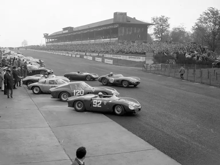 NüRBURGRING, GERMANY - MAY 27: Phil Hill / Olivier Gendebien, SEFAC Ferrari, Ferrari Dino 246 SP 0790 alongside Willy Mairesse / Mike Parkes, SEFAC Ferrari, Ferrari 330 LM/GTO 3673SA and Dan Gurney / Jo Bonnier, Porsche System Engineering, Porsche 718 GTR 046 at the start during the Nurburgring 1000 kms at Nürburgring on May 27, 1962 in Nürburgring, Germany. (Photo by LAT Images)