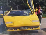 The consignor and his brother standing next to their father’s Lamborghini.