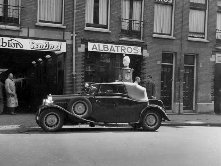 This Bugatti Type 49 Drophead Coupé stops for fuel at the Albatros Garage in Ramshorst, Holland.