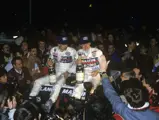 Henri Toivenen sits atop the victorious Lancia Delta with co-driver, Segio Cresto, after winning the 1986 Rallye-Monte Carlo.