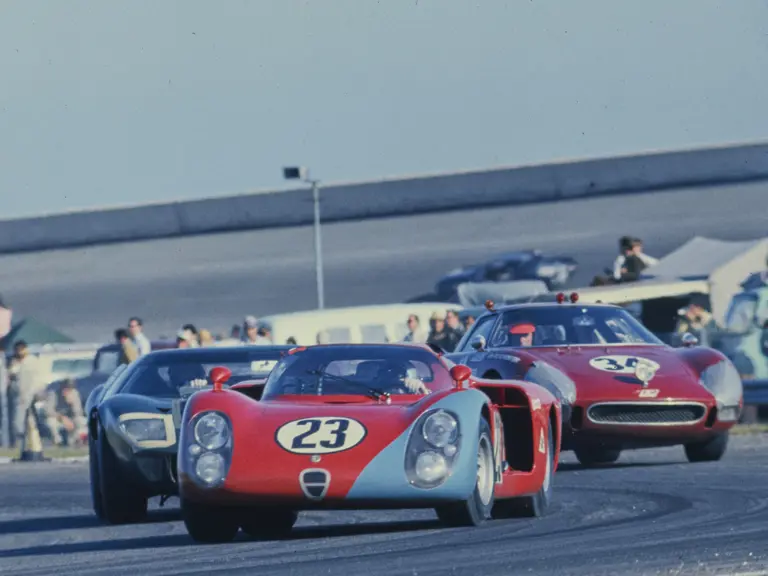 Chassis no. 015, race #23, leads a Ford GT40 and a Ferrari 250 LM through a turn at the 1968 24 Hours of Daytona.