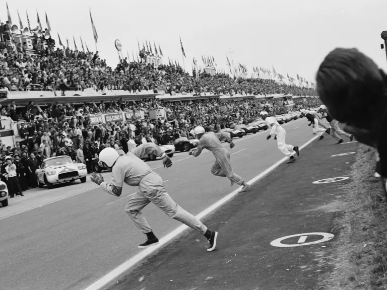 Briggs Cunningham (foreground) sprints across the track to #1, while Dick Thompson (#2) and John Fitch (#3) follow suit at the start of the 24 Hours of Le Mans.