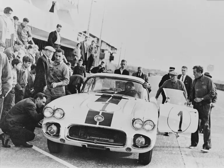 Dick Thompson (behind the wheel), Briggs Cunningham (side of door), and Alfred Momo (behind door) at the 24 Hours of Le Mans test day, April 1960.