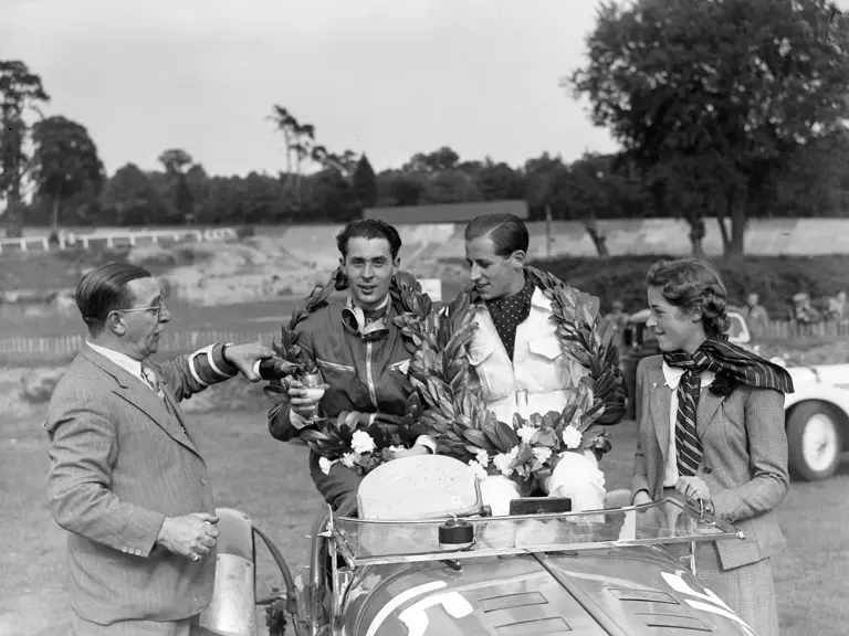 Jay Willing and Ronnie Jarvis celebrate in the Delahaye having won the 1938 3 Hour Light Car Club at Brooklands.