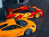 The 1990s pop art-inspired McLaren livery in scarlett red and yellow stands out next to a bright orange McLaren.