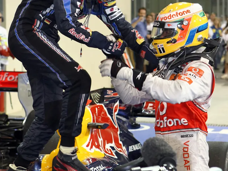 Lewis Hamilton congratulates Sebastian Vettel upon winning his first Formula 1 Drivers' Championship at the 2010 Abu Dhabi Grand Prix.