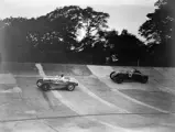 WG Everitt leads the Bentley of Earl Howe/Dudley Froy on the Brooklands banking during the 1934 BRDC 500 Miles.