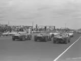 Ken Miles (#98), Dan Gurney (#99), and Bob Holbert (#97) lead the way in the trio of Works Cobras at the Bridgehampton Double 500, September 1963.