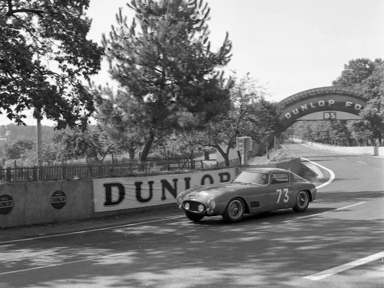 The Ferrari 250 GT Berlinetta hurtles past, driving through the 5th stage of the 1956 Tour de France on 9 July.
