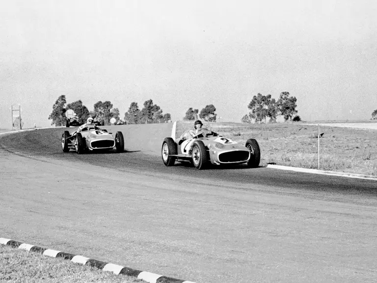 Juan Manuel Fangio (#2) leads Stirling Moss (#6) in chassis number 00009/54 at the 1955 Formula Libre Buenos Aires Grand Prix. Fangio would win the race, which used an unusual two-heat format.
