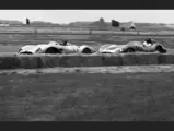 Richie Ginther behind the wheel of chassis no. 0680 MDTR (race #11) leads a Scarab (race #16) piloted by Lance Reventlow at the Santa Barbara Road Races, 1958.