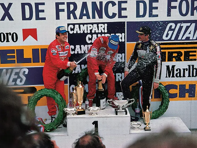 Nigel Mansell shares the podium with Niki Lauda and Patrick Tambay after finishing 3rd at the 1984 French Grand Prix.