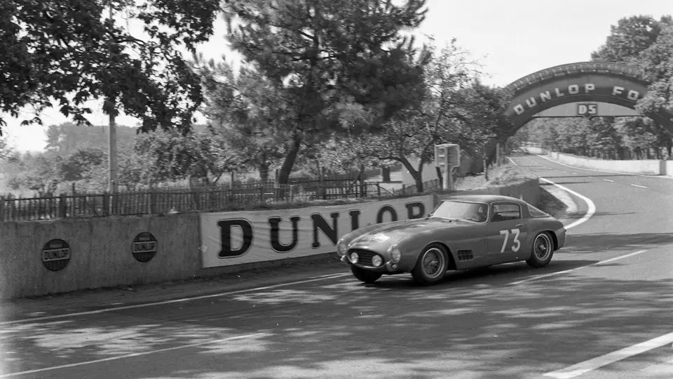 The Ferrari 250 GT Berlinetta hurtles past, driving through the 5th stage of the 1956 Tour de France on 9 July.