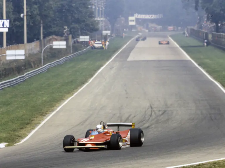 Scheckter leads the pack as he rounds the end of the main straight at Monza Circuit at the 1979 Italian Grand Prix, where the Ferrari driver finished in 1st place.
