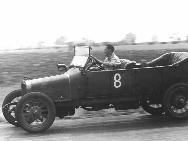The 12/16 HP Tourer is pictured being driven spiritedly. It is known to have been used in hill climb and motor circuit meets.