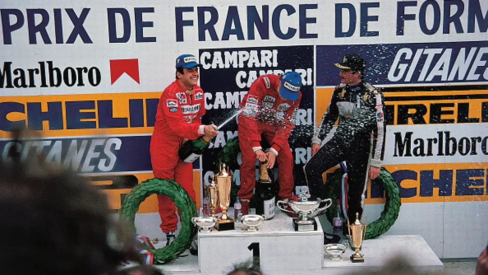 Nigel Mansell shares the podium with Niki Lauda and Patrick Tambay after finishing 3rd at the 1984 French Grand Prix.