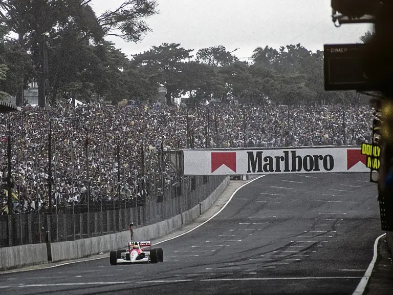 Ayrton Senna crosses the line victorious at the 1991 Brazilian Grand Prix.