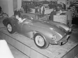 James Bond actress Eunice Gayson sits inside chassis DB3S/111 while the car is exhibited on the Aston Martin stand at the 1955 British Motor Show in Earls Court, London.