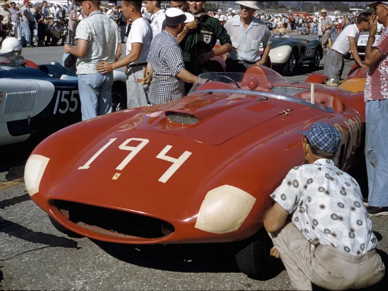 Chassis no. 0478 AM donning #194 with owner Tony Parravano (hat and checkered shirt) and driver Ken Miles (green race suit) chatting prior to the Santa Barbara race, September 1955.