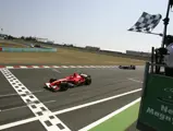Michael Schumacher crosses the line in first place at the 2006 French Grand Prix.