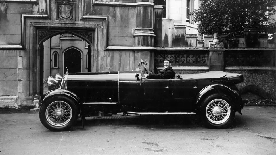 The Lagonda captured with a beaming driver, thought to date from the late 1950s, early 1960s.