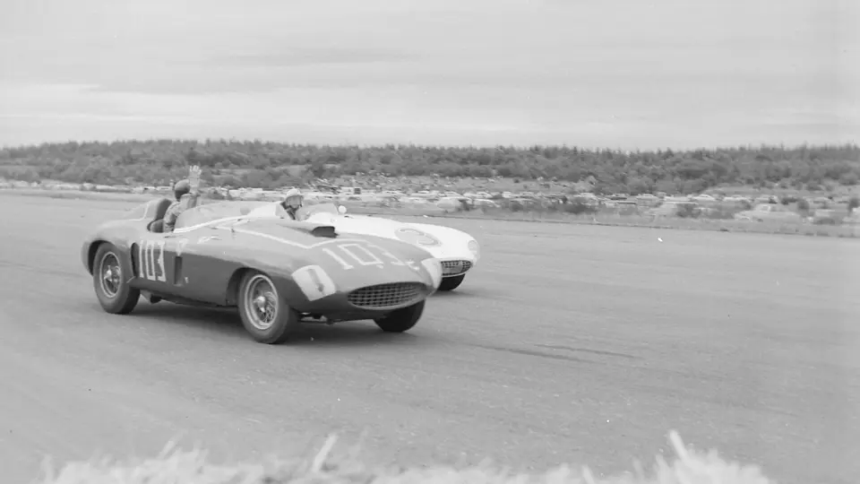 Carroll Shelby, behind the wheel of chassis no. 0478 AM (#103), gives a friendly wave to Phil Hill and his 750 Monza (#3) after beating him in the feature race at the 31 July 1955 SCCA Nationals held at Bremerton, Washington.
