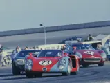 Chassis no. 015, race #23, leads a Ford GT40 and a Ferrari 250 LM through a turn at the 1968 24 Hours of Daytona.