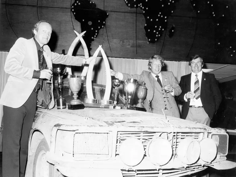 Björn Waldegård (left) and Mikkola Hannu (middle) pose with the collective trophies on chassis 836 following a Mercedes 1-2-3-4 finish at the 1979 Bandama Rally.