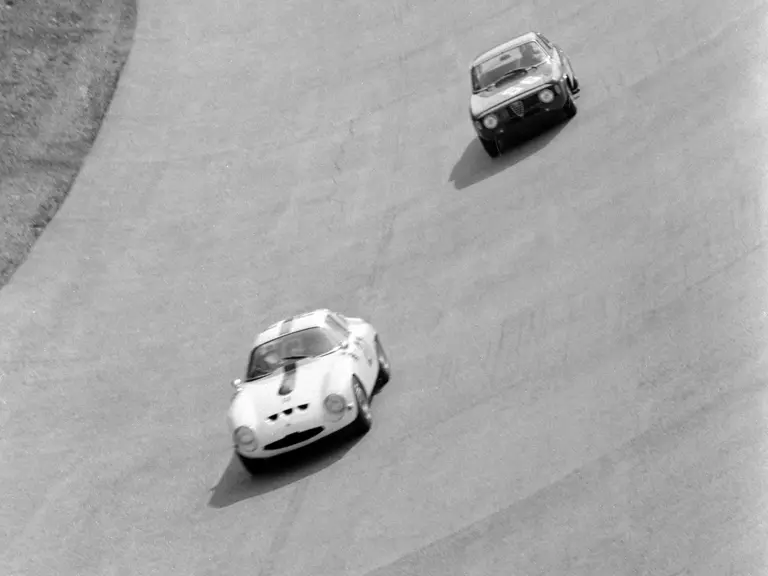 Chassis number 750061 (#27) leads an Autodelta Alfa Romeo Giulia Sprint GTA (#56) through the high bank at Monza in the 1965 1000 KM of Monza.