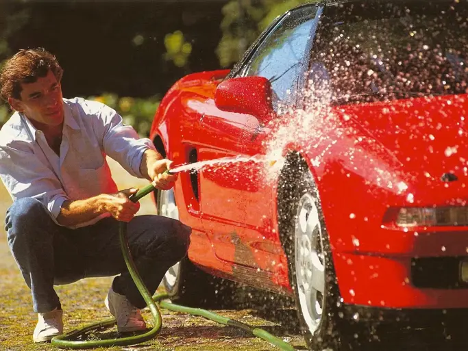Ayrton Senna is pictured washing the NSX in a timeless shot.