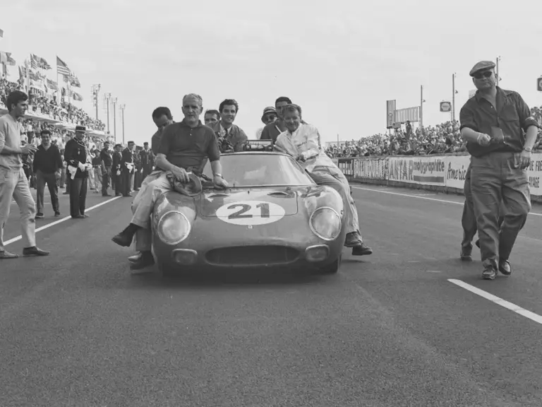 Chassis 5893 and Luigi Chinetti’s N.A.R.T. team celebrating their first overall finish at the 1965 24 Hours of Le Mans.