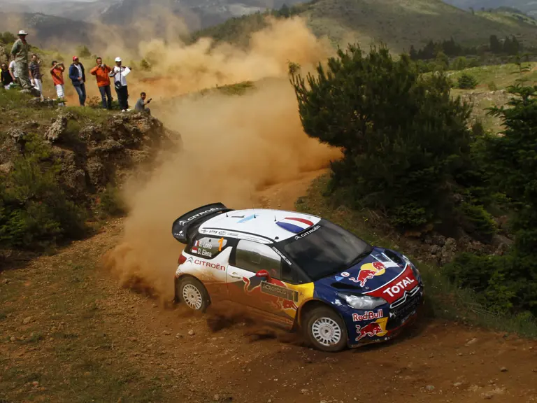 The Citroën navigates the crowd-lined course at the 2012 Acropolis Rally, won by Loeb and Elena.