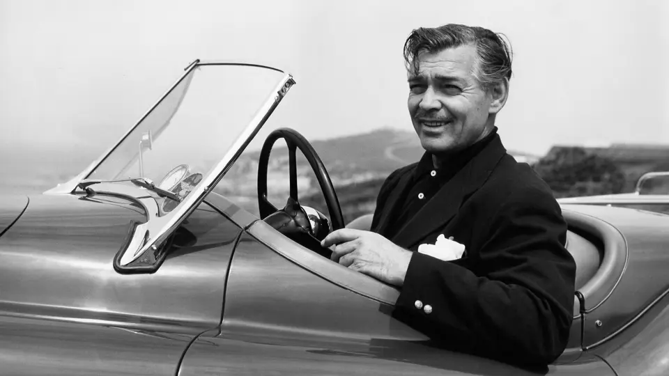 Clark Gable looks delighted with his new Jaguar, pictured having just taken delivery of “MDU 420”.