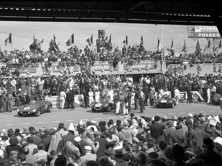 Chassis 0546 LM captured in the Le Mans pit lane alongside the three Works Jaguar D-Types.