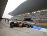 Romain Grosjean leaves the pit lane at the 2013 Indian Grand Prix.