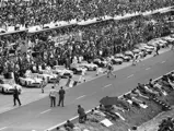 Briggs Cunningham, Dick Thompson, and John Fitch jump into their respective Corvettes as the rest of the field follows suit.
