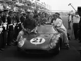Chassis no. 5893 following the triumphant first overall finish for Luigi Chinetti’s NART team at the 1965 24 Hours of Le Mans. Masten Gregory behind the wheel and co-driver Jochen Rindt in the passenger seat.
