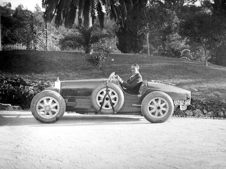 Lord Cholmondeley pictured with his Bugatti shortly after delivery in 1925 (note the temporary French registration plates).