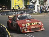 The Georg Loos Porsche 935 #39, driven by Toine Hezemans, Tim Schenken, and Hans Heyer, rounds a corner at the 1977 24 Hours Le Mans.