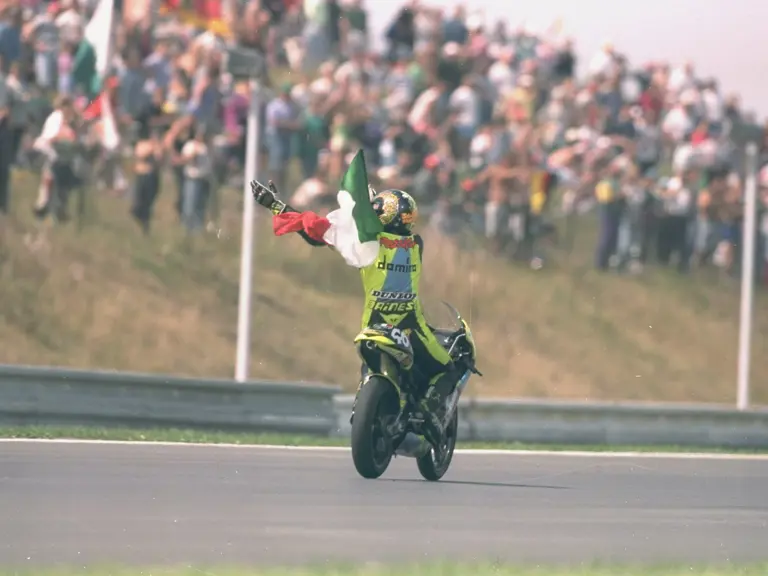 Valentino Rossi on his first career celebration lap having won the 1996 Czech Grand Prix with chassis 1291195.