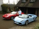 Rod Stewart poses with his Ferrari 575 Superamerica and Lamborghini Gallardo Spyder outside his home in 2009.