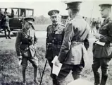King George V stands with the Prince of Wales, later King Edward VIII, on a wartime visit to France in 1917. Chassis 64RB is seen in the background.