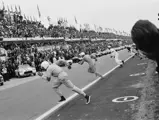 Briggs Cunningham (foreground) sprints across the track to #1, while Dick Thompson (#2) and John Fitch (#3) follow suit at the start of the 24 Hours of Le Mans.