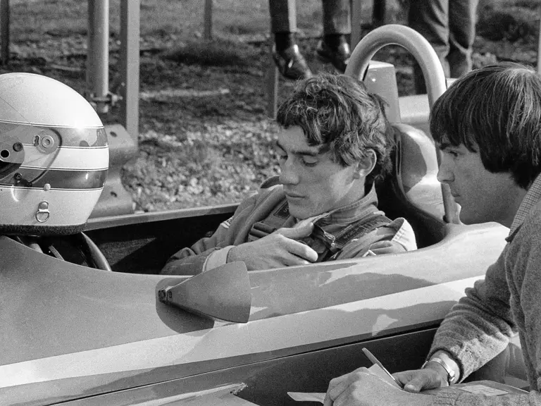Ayrton Senna sitting in the Ralt RT3 speaks to an engineer at Thruxton in November of 1982.