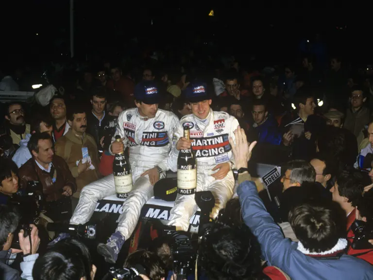 Henri Toivenen sits atop the victorious Lancia Delta with co-driver, Segio Cresto, after winning the 1986 Rallye-Monte Carlo.