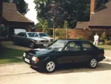 The 190 E 2.3-16 is pictured with other cars at Ayrton Senna’s Esher address. Senna can be seen loading into the boot of the closest Mercedes-Benz.